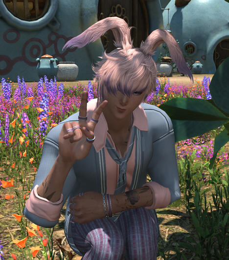 Pink, blue. and purple colored bunny boy. Pink hair, purple highlights, Blue jacket, pink shirt, and blue tie. They are making a peace sign.