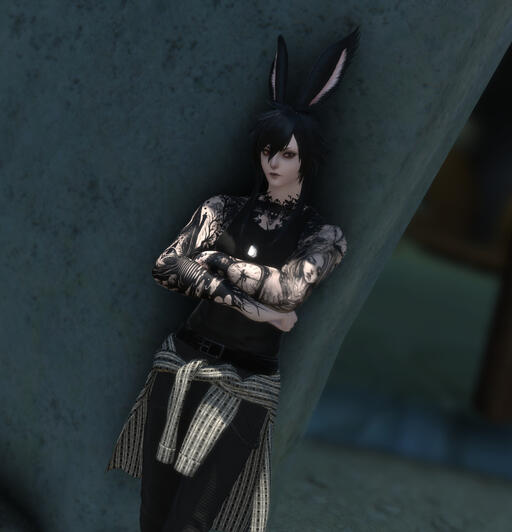 Pale bunny boy with red eyes, black hair, long ears, and tattoos. The tattoos are themed around death and time. He is wearing a black tank top and dog tags.